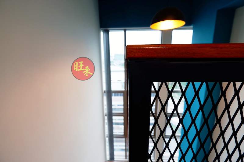 Close view of the loft's mesh railing and timber handrail beside a window - Office loft with a cantilevered steel and timber staircase (HomeOffice) | Wong Lye, BCA General Builder Class 2, Singapore