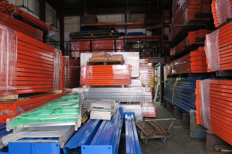 Warehouse with racking components stacked in rows - Pallet racking beams and frames stacked in a warehouse (M12) | Wong Lye, BCA General Builder Class 2, Singapore