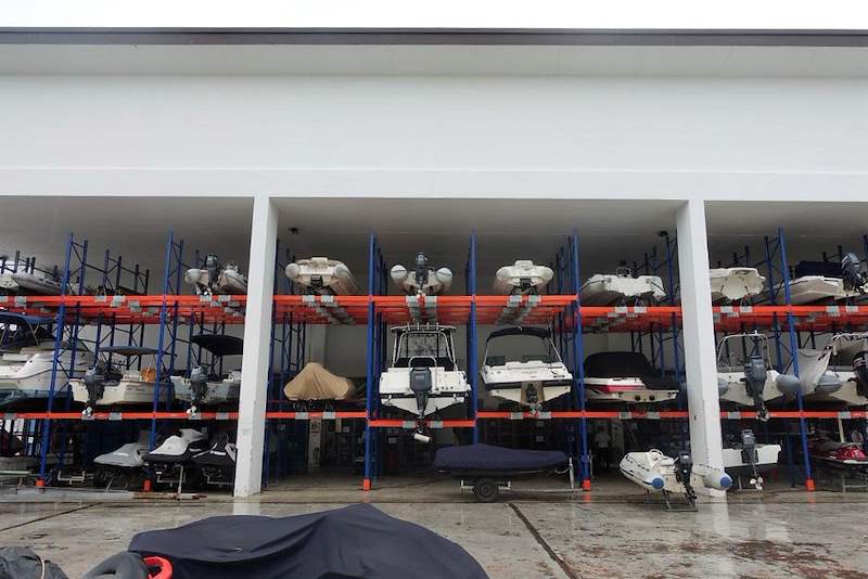 Wide view of two-tier boat racking under the shed, boats resting on bunks across several bays - Heavy-duty racking for boats and jet skis (Sentosa) | Wong Lye, BCA General Builder Class 2, Singapore