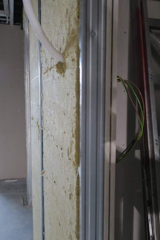 Close-up of rockwool insulation between the studs with cabling run through - Music rehearsal studio fit-out with a faceted timber ceiling (Studio) | Wong Lye, BCA General Builder Class 2, Singapore