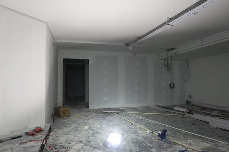 Bare space with plastered partitions and a work light - Music rehearsal studio fit-out with a faceted timber ceiling (Studio) | Wong Lye, BCA General Builder Class 2, Singapore