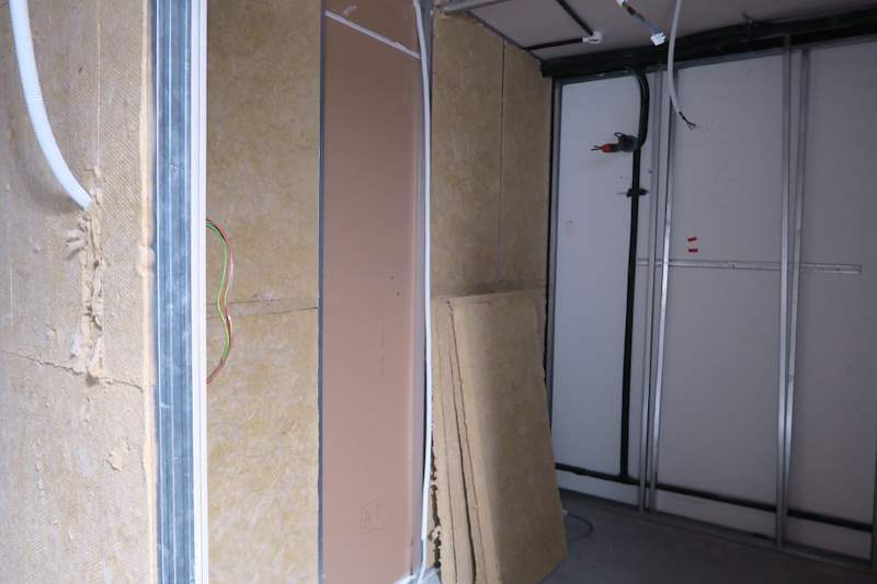 Construction: stud wall with insulation and the ceiling opening above - Music rehearsal studio fit-out with a faceted timber ceiling (Studio) | Wong Lye, BCA General Builder Class 2, Singapore
