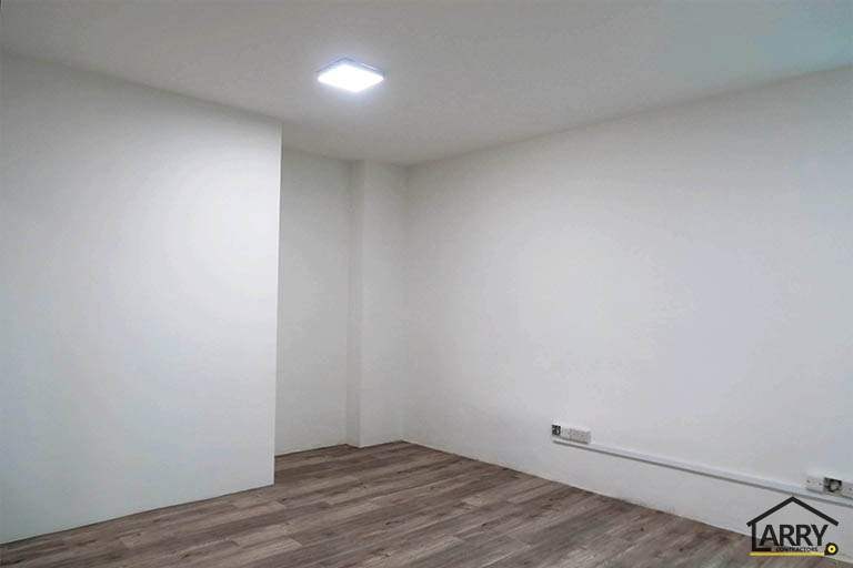 Small room with white walls and timber-look flooring - Framed glass frontage and steel entrance stair for an industrial unit (M09) | Wong Lye, BCA General Builder Class 2, Singapore