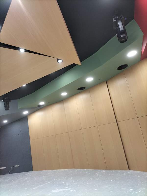 Curved timber wall panels with downlights and speakers above - Music rehearsal studio fit-out with a faceted timber ceiling (Studio) | Wong Lye, BCA General Builder Class 2, Singapore