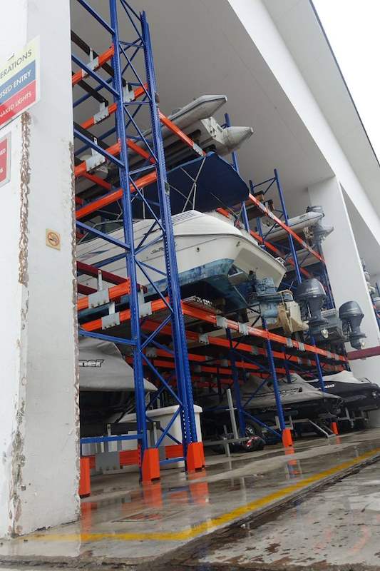 Racking bay with boats and outboard motors stored on the tiers, wet floor below - Heavy-duty racking for boats and jet skis (Sentosa) | Wong Lye, BCA General Builder Class 2, Singapore