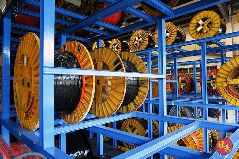 Cable drums seated on the blue racking, seen close up - Heavy-duty cable drum racking in a cable yard (TSE) | Wong Lye, BCA General Builder Class 2, Singapore