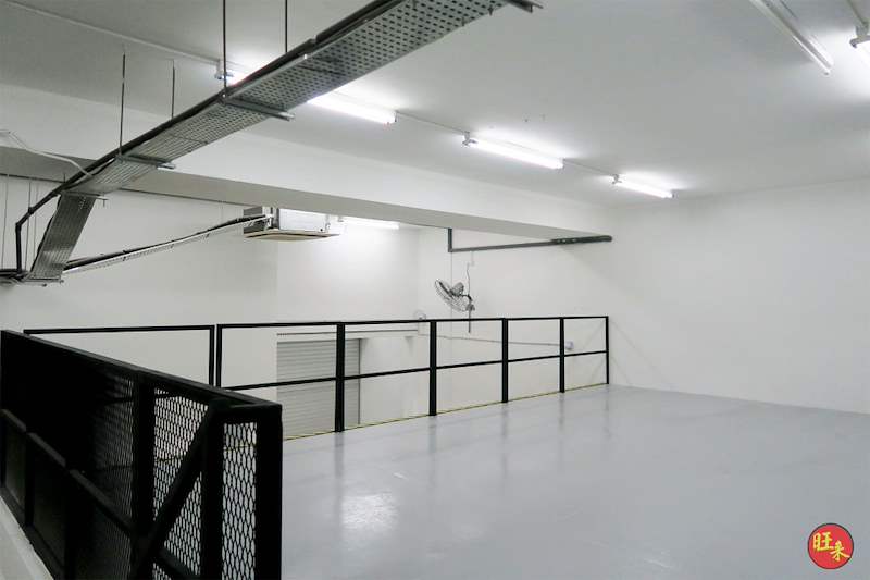 On the mezzanine deck - grey-coated floor, mesh balustrade and ceiling-mounted air conditioning - Steel mezzanine floor with staircase in a factory unit (OverseaFactory) | Wong Lye, BCA General Builder Class 2, Singapore
