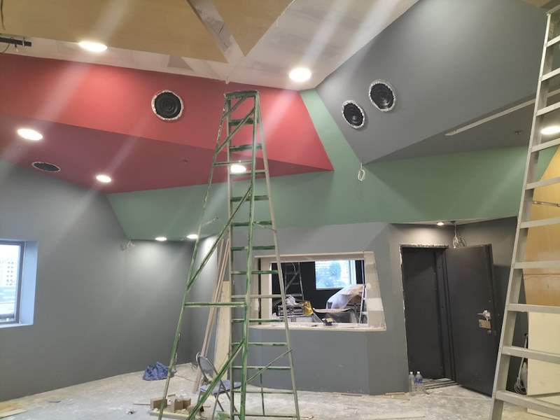 Painting stage - grey and red walls, ladders and the control-room window - Music rehearsal studio fit-out with a faceted timber ceiling (Studio) | Wong Lye, BCA General Builder Class 2, Singapore