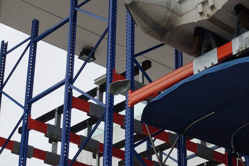 Blue uprights and orange beams seen from below a stored boat - Heavy-duty racking for boats and jet skis (Sentosa) | Wong Lye, BCA General Builder Class 2, Singapore