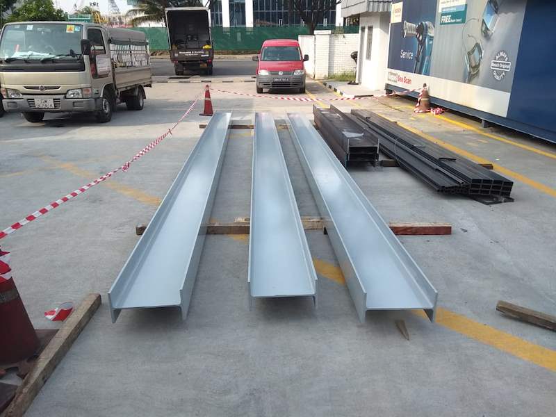 Galvanised steel channel sections laid out in the yard - Steel mezzanine platform in a factory (M22) | Wong Lye, BCA General Builder Class 2, Singapore