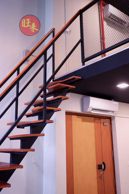Staircase with timber treads and a black steel railing at the loft edge, wall-mounted air conditioner beside it - Office loft with a cantilevered steel and timber staircase (HomeOffice) | Wong Lye, BCA General Builder Class 2, Singapore
