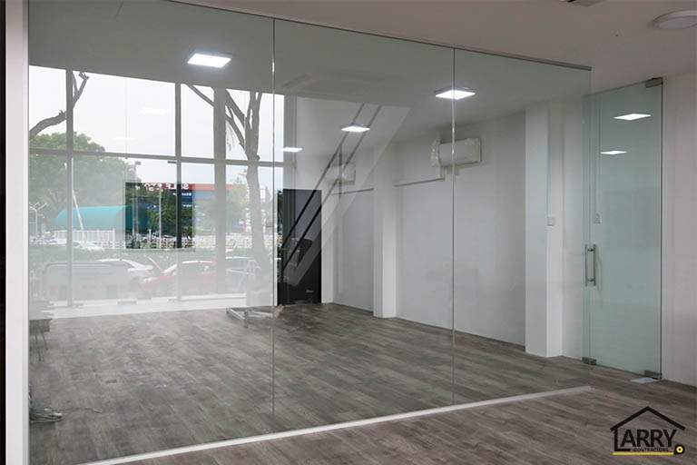 Interior with a glass partition and glass door over timber-look vinyl flooring - Framed glass frontage and steel entrance stair for an industrial unit (M09) | Wong Lye, BCA General Builder Class 2, Singapore