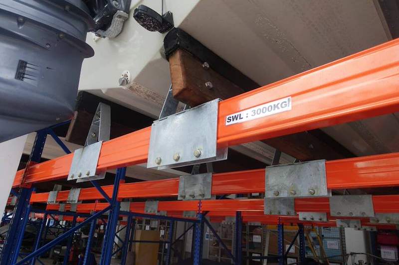 Line of bunk brackets along a beam carrying a boat, with the safe working load label visible - Heavy-duty racking for boats and jet skis (Sentosa) | Wong Lye, BCA General Builder Class 2, Singapore