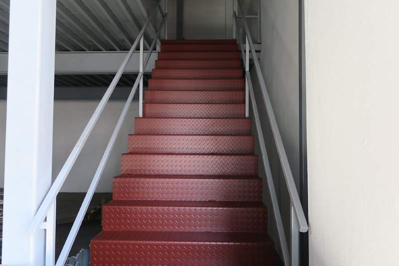 Steel staircase with red checker-plate treads and grey pipe railings - Two-level steel mezzanine with staircases (HF0107) | Wong Lye, BCA General Builder Class 2, Singapore