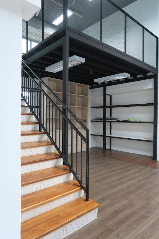 The loft platform and staircase seen from the floor of the unit - Steel loft platform with staircase in an industrial unit (Loft) | Wong Lye, BCA General Builder Class 2, Singapore
