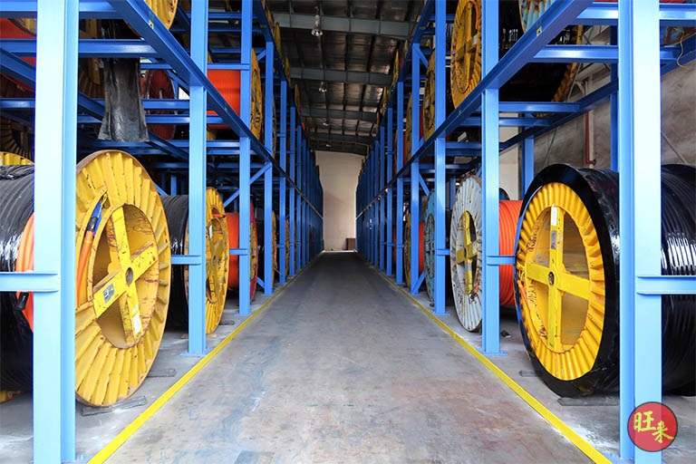 After: aisle between two-tier blue racks loaded with cable drums - Heavy-duty cable drum racking in a cable yard (TSE) | Wong Lye, BCA General Builder Class 2, Singapore