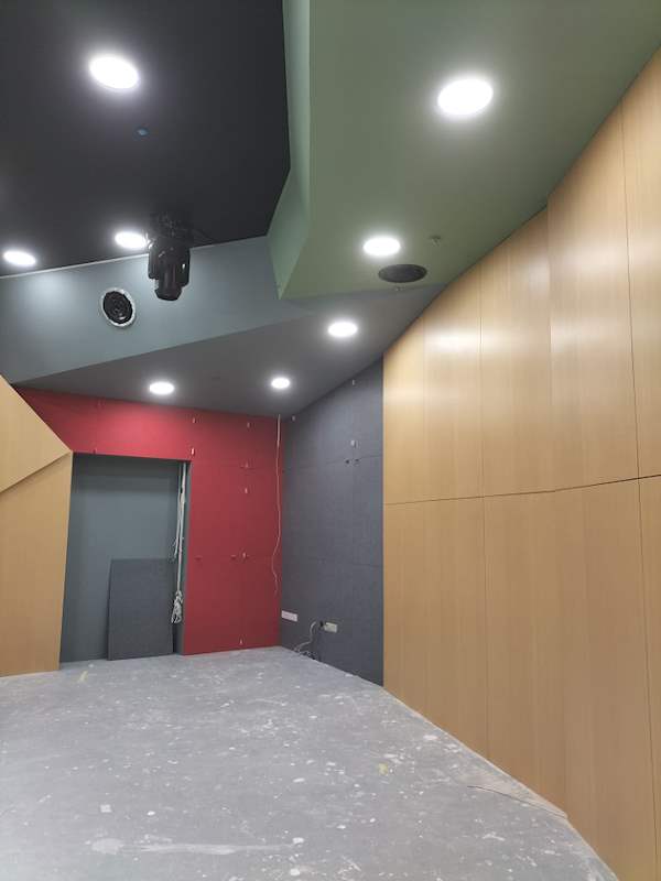 Timber wall panels with grey and red walls and a dark ceiling - Music rehearsal studio fit-out with a faceted timber ceiling (Studio) | Wong Lye, BCA General Builder Class 2, Singapore