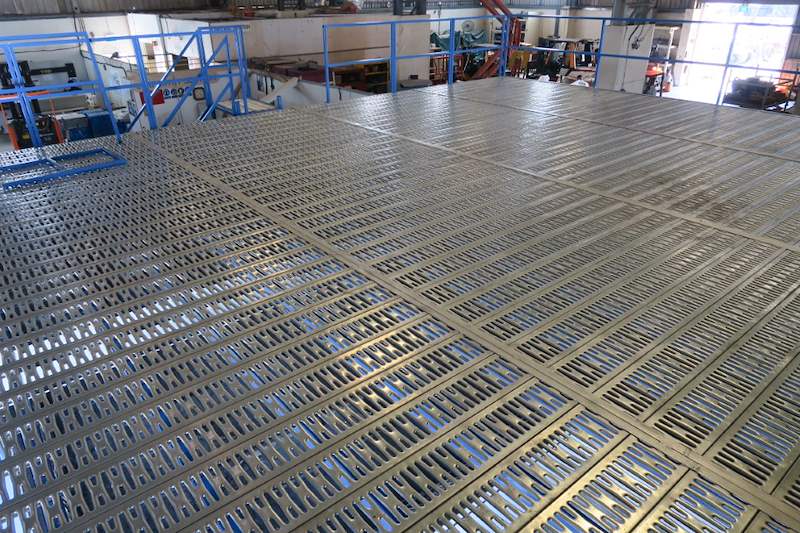 Close view of the galvanised grating deck panels on the mezzanine - Steel mezzanine platform in a factory (M22) | Wong Lye, BCA General Builder Class 2, Singapore