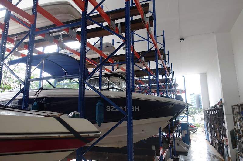 Boat on an upper tier of the blue steel racking, seen from the aisle - Heavy-duty racking for boats and jet skis (Sentosa) | Wong Lye, BCA General Builder Class 2, Singapore