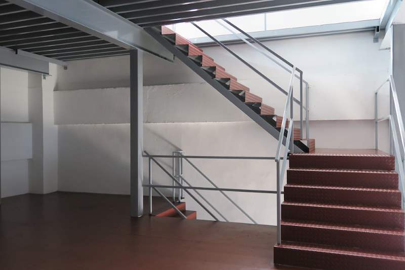 Mezzanine level with grey steel beams, railing and a stair with red treads - Two-level steel mezzanine with staircases (HF0107) | Wong Lye, BCA General Builder Class 2, Singapore