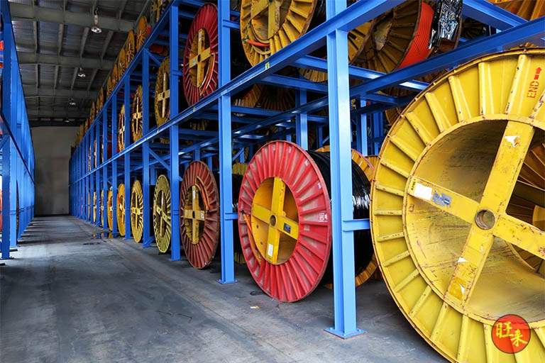 Large cable drums on the blue racking along the aisle - Heavy-duty cable drum racking in a cable yard (TSE) | Wong Lye, BCA General Builder Class 2, Singapore
