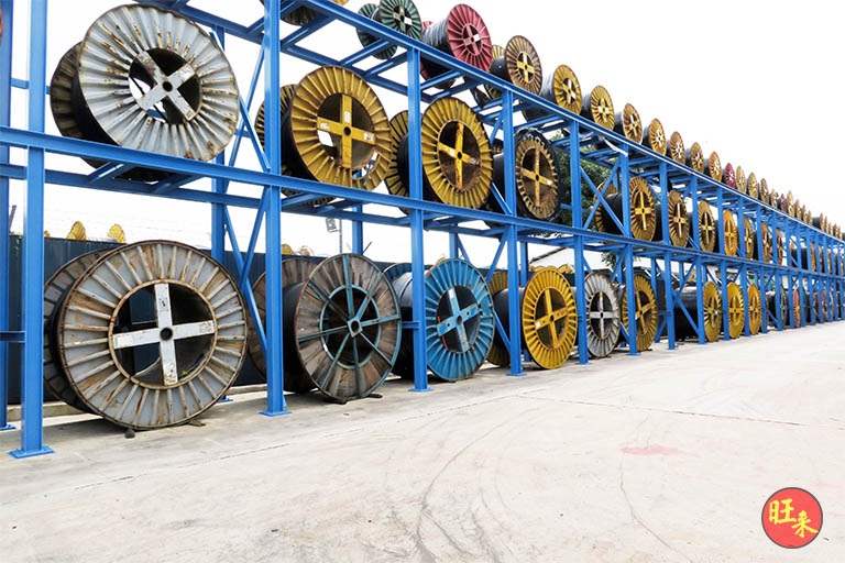 Two-tier drum racks along the yard holding drums of several colours - Heavy-duty cable drum racking in a cable yard (TSE) | Wong Lye, BCA General Builder Class 2, Singapore
