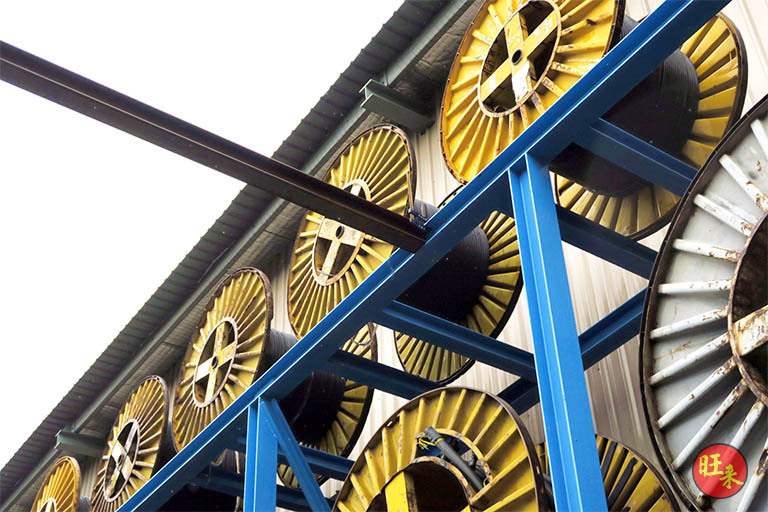 Looking up at drums on the upper tier of the racking - Heavy-duty cable drum racking in a cable yard (TSE) | Wong Lye, BCA General Builder Class 2, Singapore