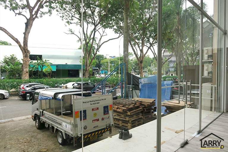 Looking out through the glass frontage to the car park - Framed glass frontage and steel entrance stair for an industrial unit (M09) | Wong Lye, BCA General Builder Class 2, Singapore