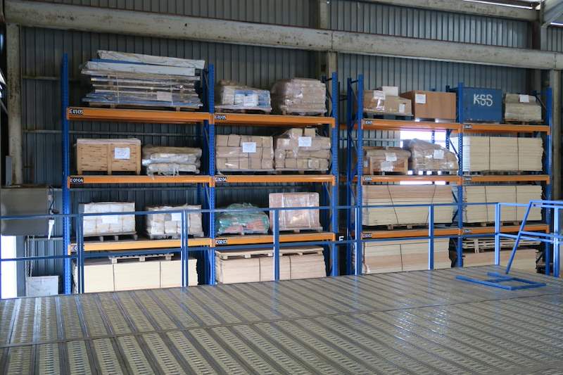 Pallet racking loaded with goods beside the mezzanine deck - Steel mezzanine platform in a factory (M22) | Wong Lye, BCA General Builder Class 2, Singapore