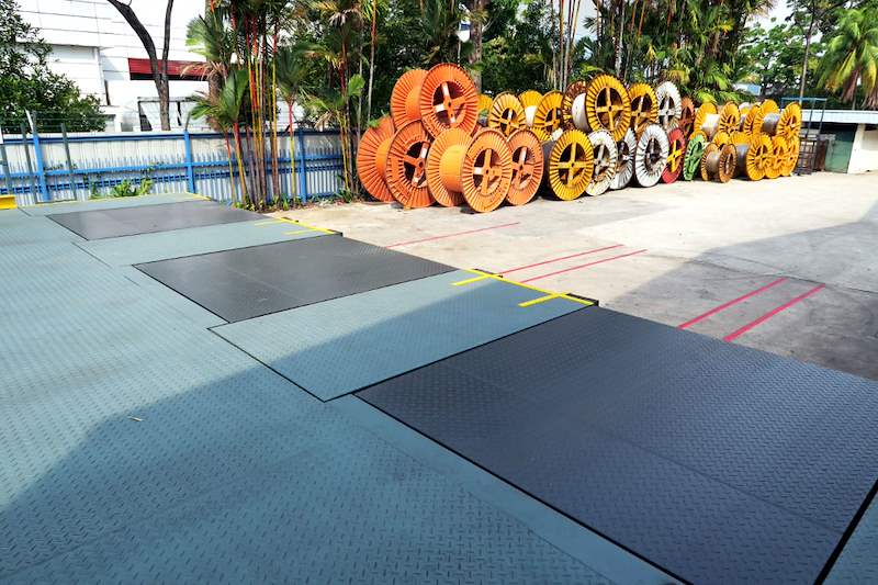 Checker-plate surface of the steel dock platforms, cable drums in the background - Heavy-duty cable drum racking in a cable yard (TSE) | Wong Lye, BCA General Builder Class 2, Singapore